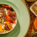 A vibrant breakfast bowl with yogurt, fruits, and seeds, perfect for a healthy morning start.